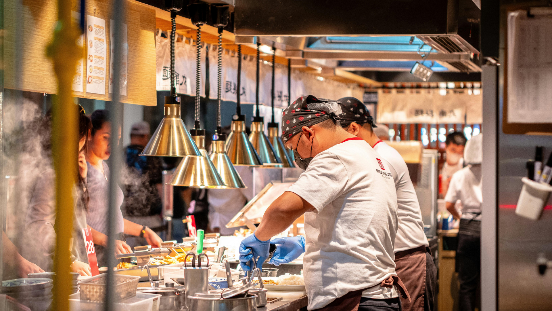 Employees preparing foods in kitchen
