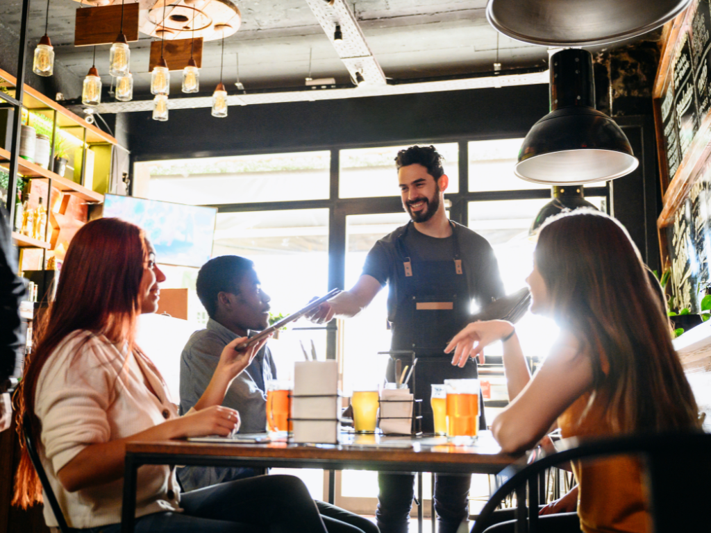 A group of people dining happily at a restaurant table.